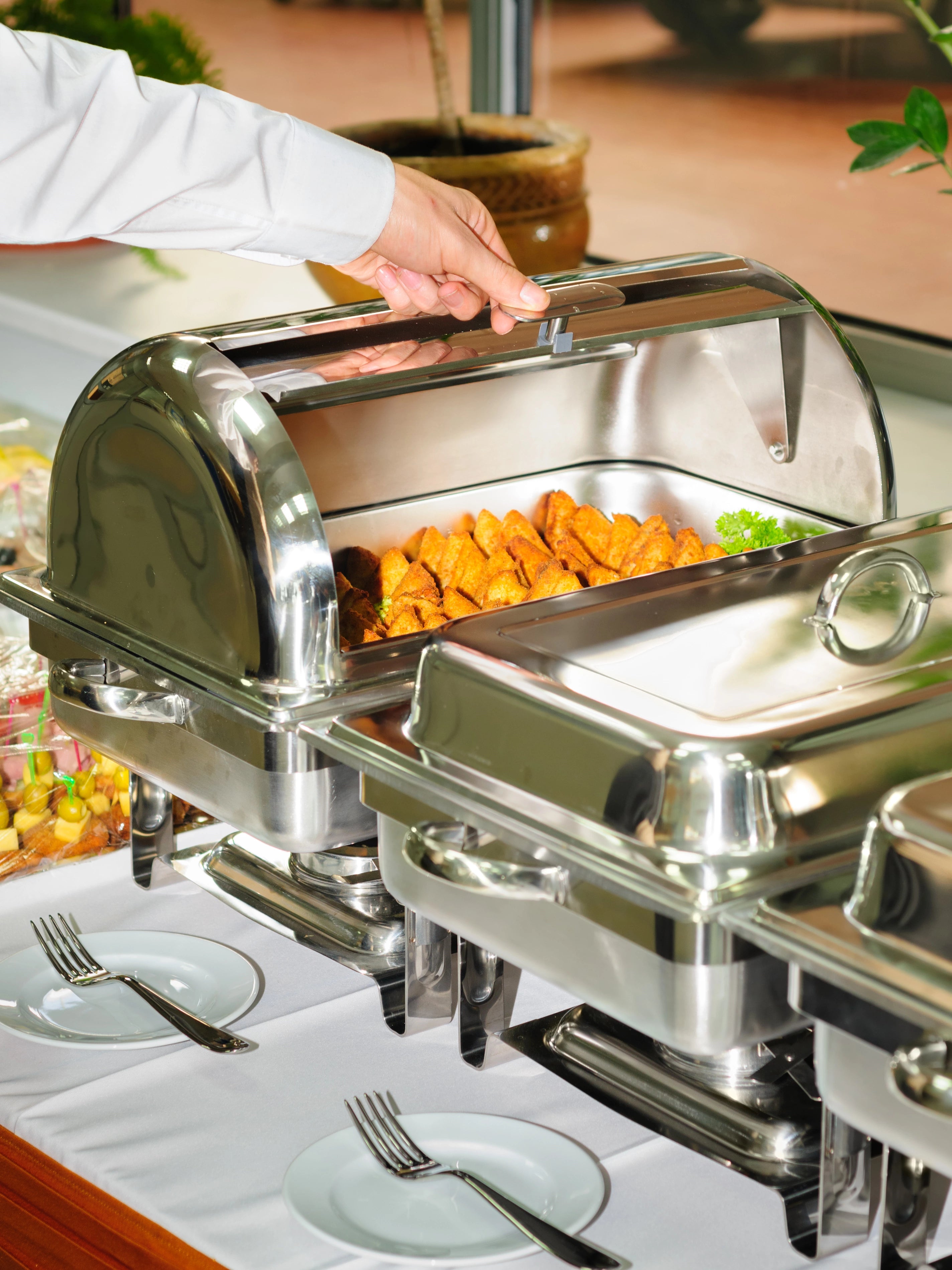 Catering-Speisen, die jeweils mit Brennpaste warmgehalten werden.
